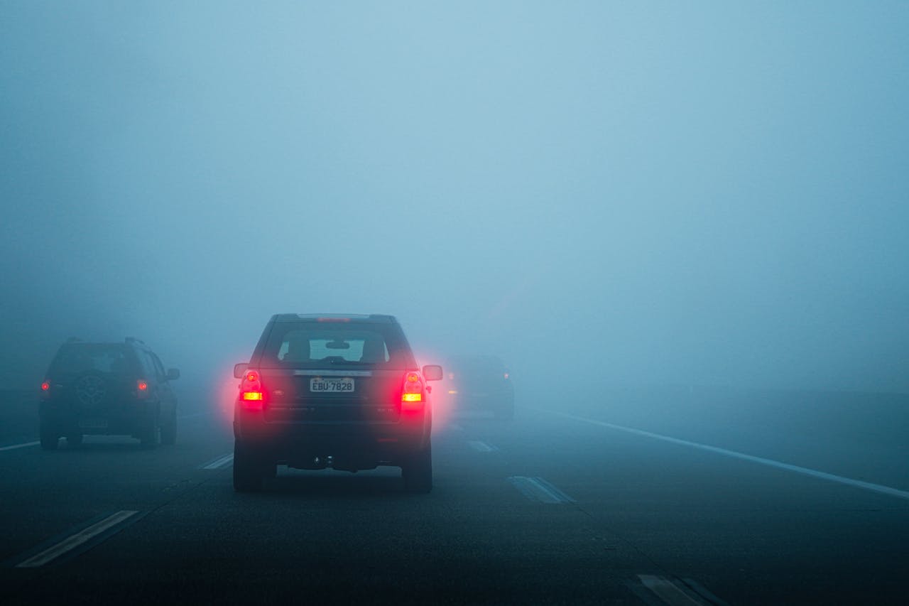 Vehicles navigating a foggy highway in Santos, São Paulo, creating a mysterious atmosphere.